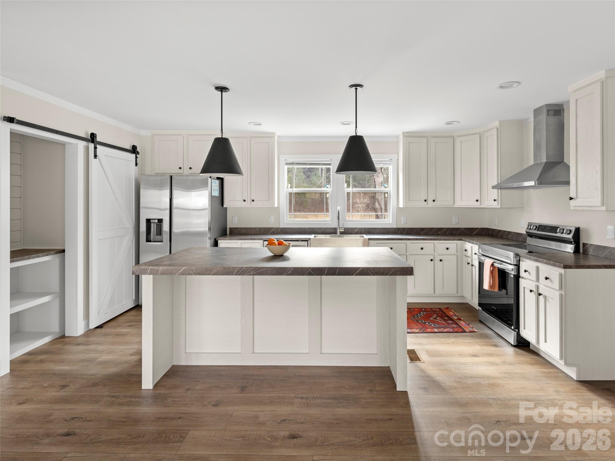 2095 Emmas Grove Road Fairview, NC 28730 - Photo 9 of 24 a kitchen with stainless steel appliances granite countertop a sink a stove and refrigerator