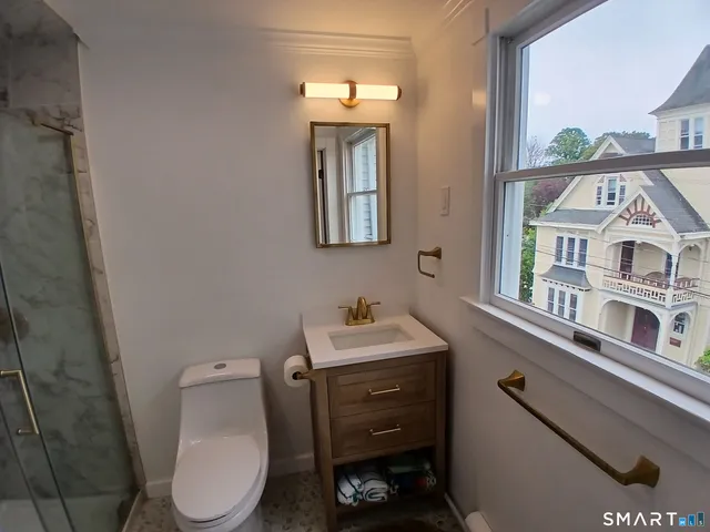 a kitchen with stainless steel appliances granite countertop a refrigerator a sink dishwasher a stove and a refrigerator with wooden floor