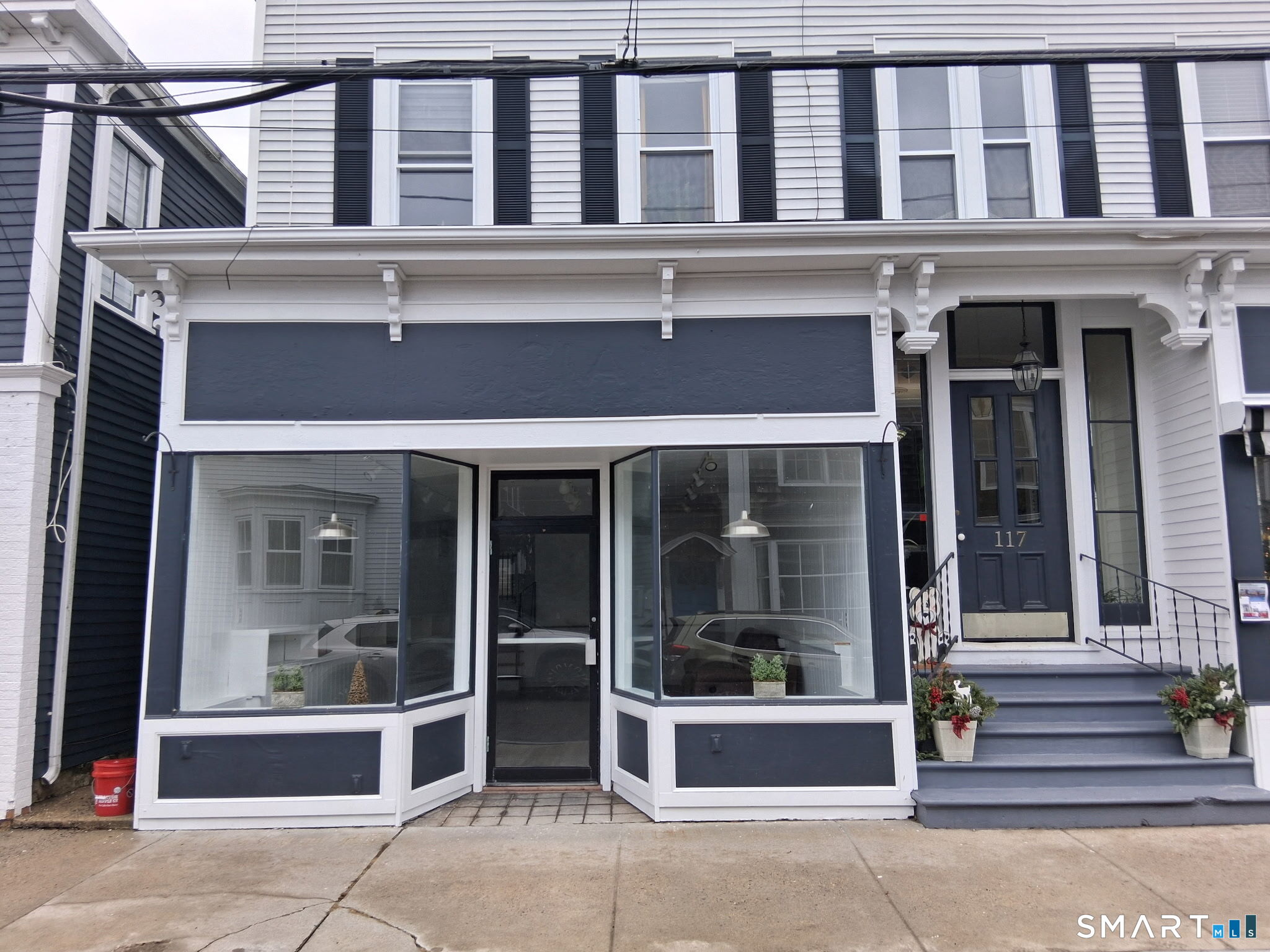 117 Water Street Stonington, CT 06378 - Photo 7 of 40 a front view of a building with a entrance