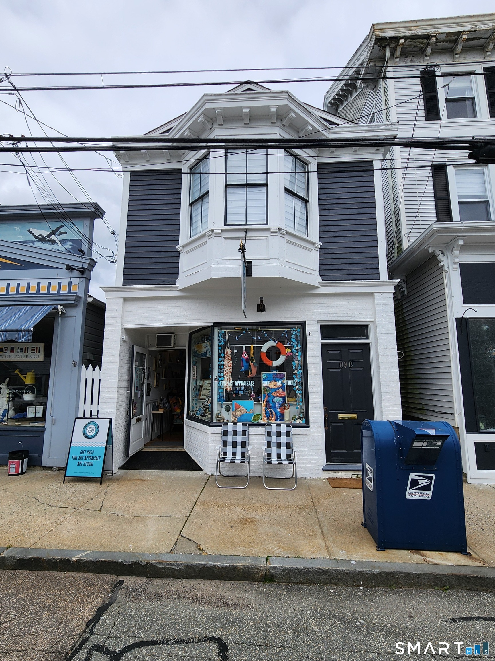 117 Water Street Stonington, CT 06378 - Photo 10 of 40 a front view of a building with lots of stuff