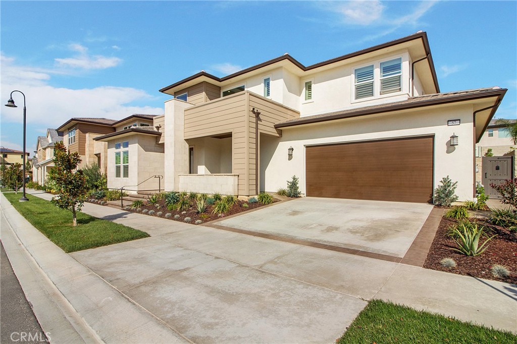 57 Sagan Way Irvine, CA 92618 - Photo 1 of 40 a front view of a house with a yard and garage