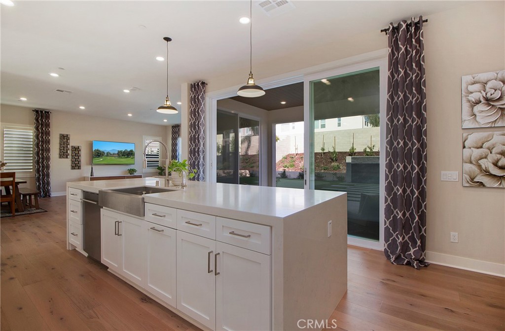 57 Sagan Way Irvine, CA 92618 - Photo 12 of 40 a kitchen with white cabinets and sink