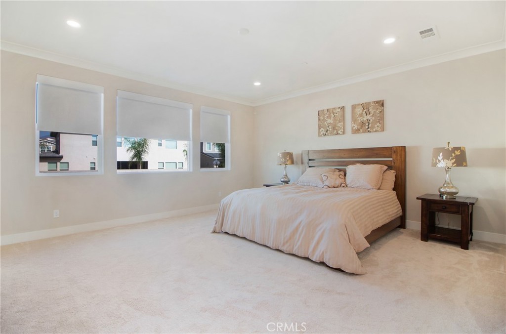 57 Sagan Way Irvine, CA 92618 - Photo 17 of 40 a bedroom with a bed and a lamp