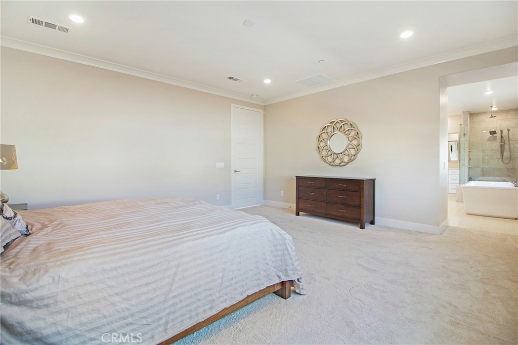 57 Sagan Way Irvine, CA 92618 - Photo 18 of 40 a spacious bedroom with a bed and a view of bathroom