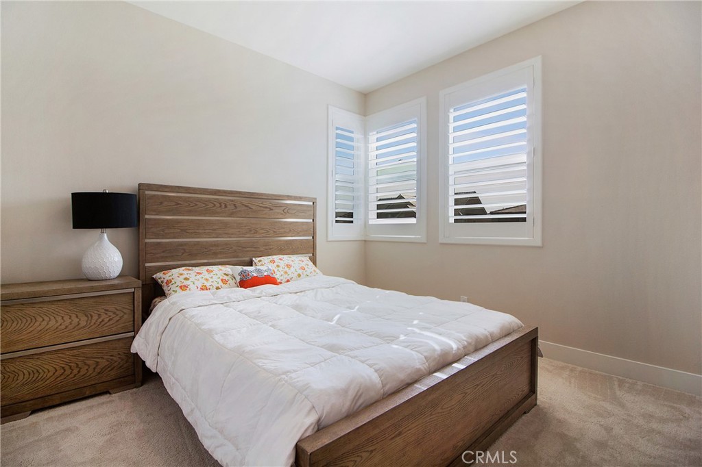 57 Sagan Way Irvine, CA 92618 - Photo 23 of 40 a bedroom with a bed and wooden floor
