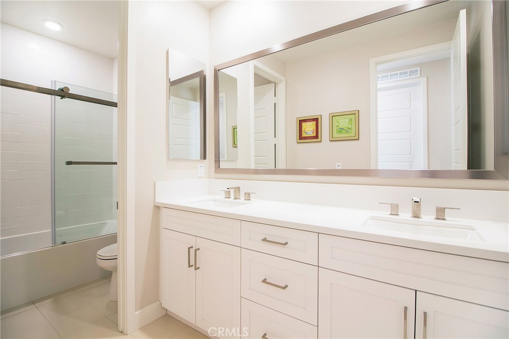 57 Sagan Way Irvine, CA 92618 - Photo 24 of 40 a bathroom with a sink a toilet and a mirror