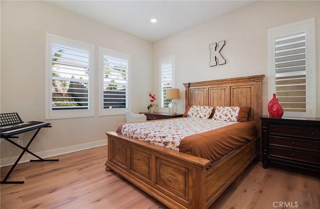 57 Sagan Way Irvine, CA 92618 - Photo 29 of 40 a bedroom with a bed and wooden floor