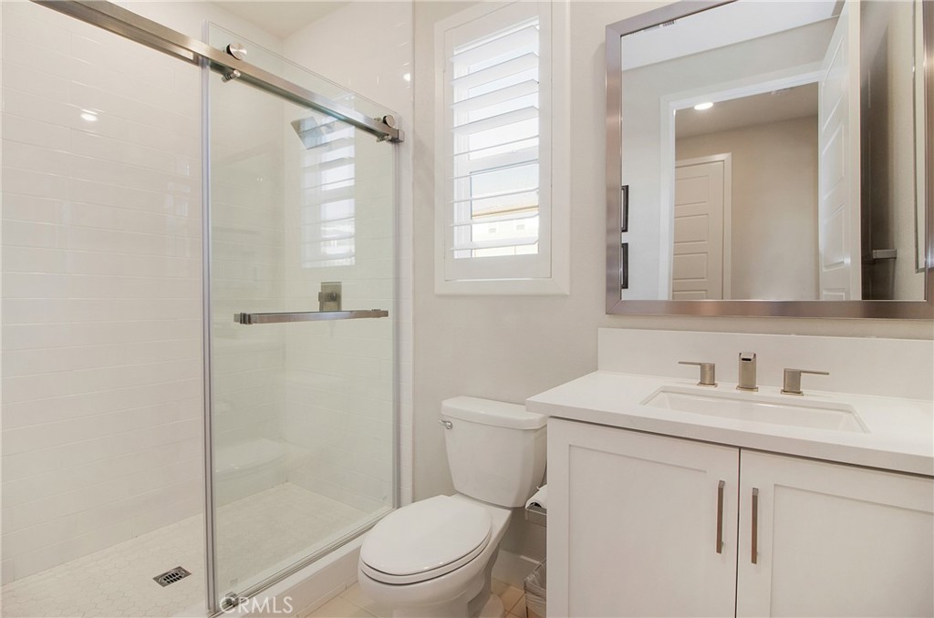 57 Sagan Way Irvine, CA 92618 - Photo 31 of 40 a bathroom with a sink a toilet and shower