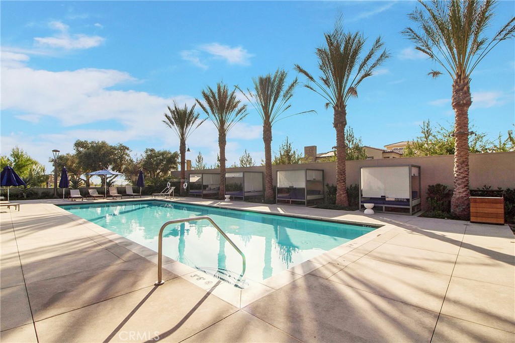 57 Sagan Way Irvine, CA 92618 - Photo 38 of 40 a view of a swimming pool with a lounge chair and palm trees