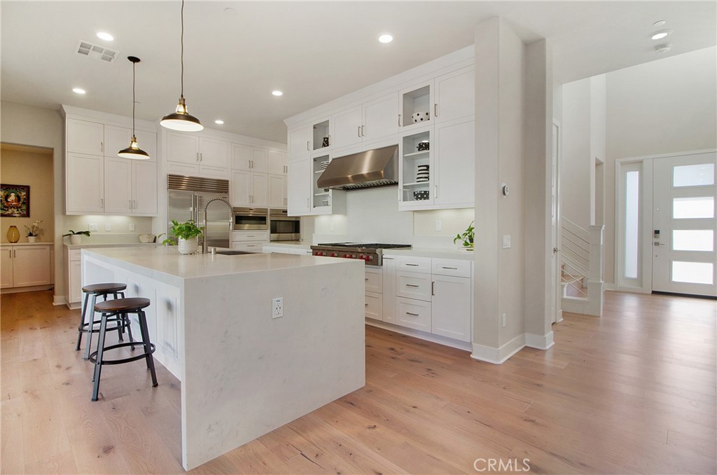57 Sagan Way Irvine, CA 92618 - Photo 10 of 40 a large white kitchen with lots of counter space and appliances