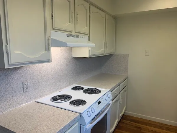 a kitchen with a stove and a microwave