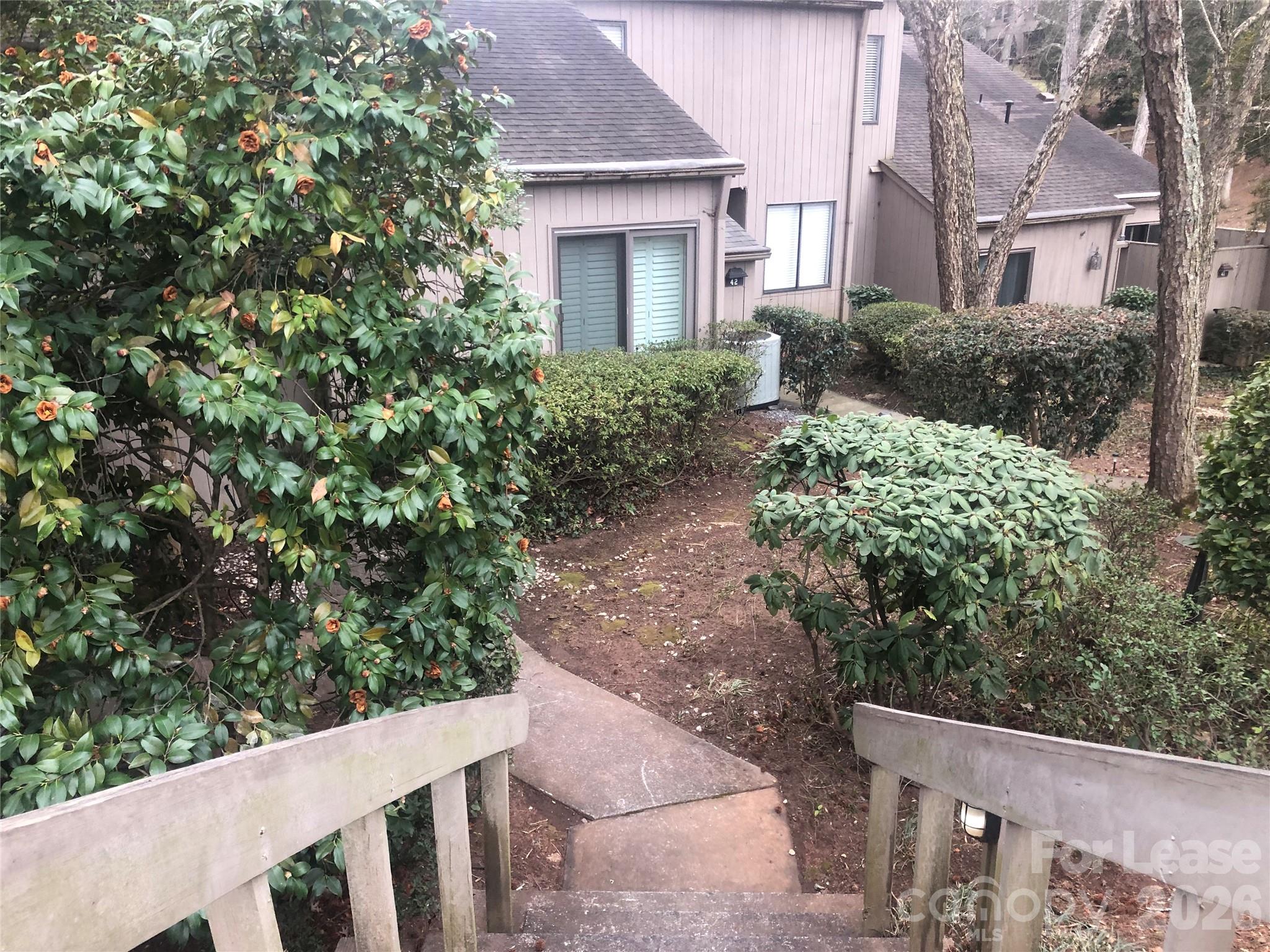 43 Old Post Road Clover, SC 29710 - Photo 3 of 12 a view of a house with brick walls plants and large trees
