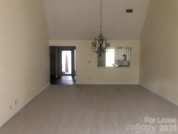 a view of a chandelier in big room and chandelier