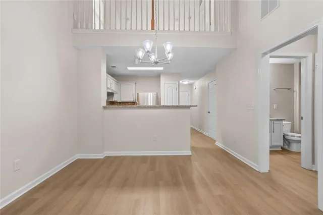 wooden floor in an empty room and a kitchen