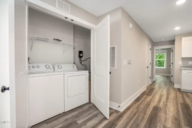 a utility room with cabinets washer and dryer