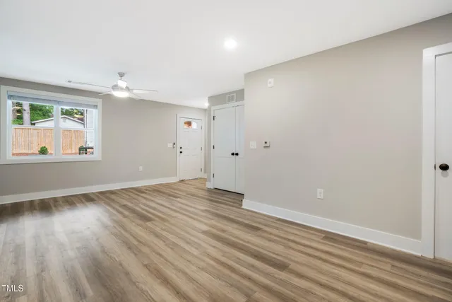 wooden floor in an empty room with a window