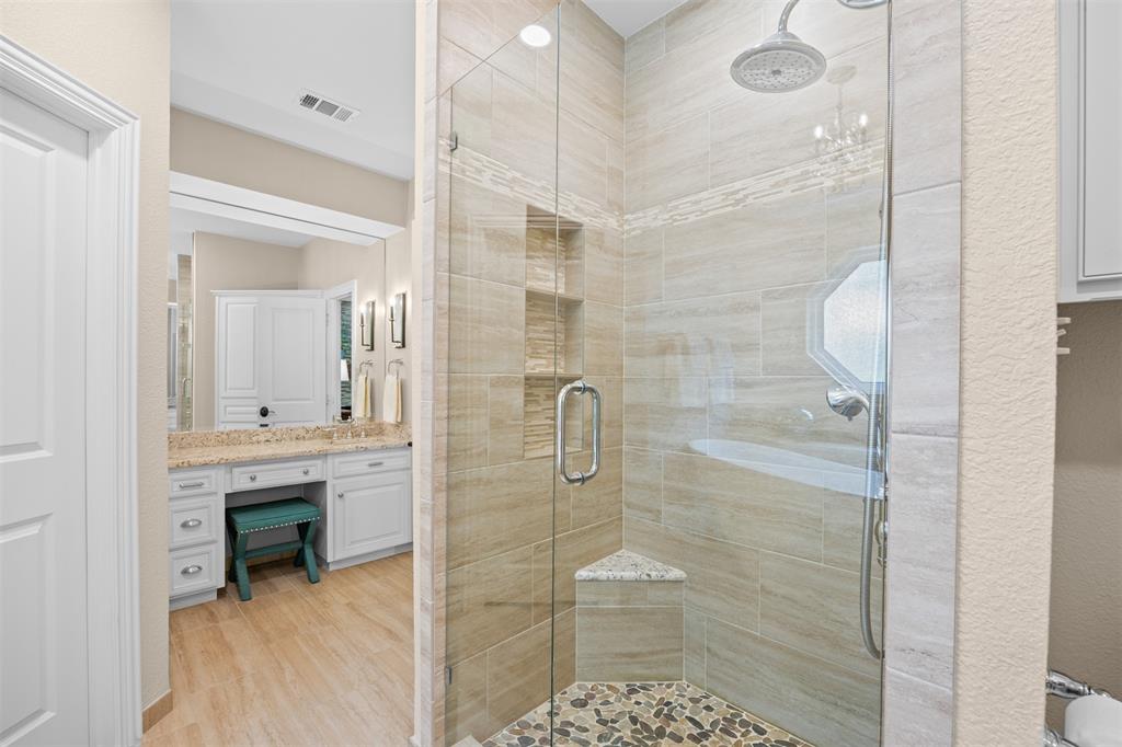 7225 Moss Ridge Road Parker, TX 75098 - Photo 12 of 40 The bathroom features a spacious shower with glass enclosure, tiled walls, and a pebble floor