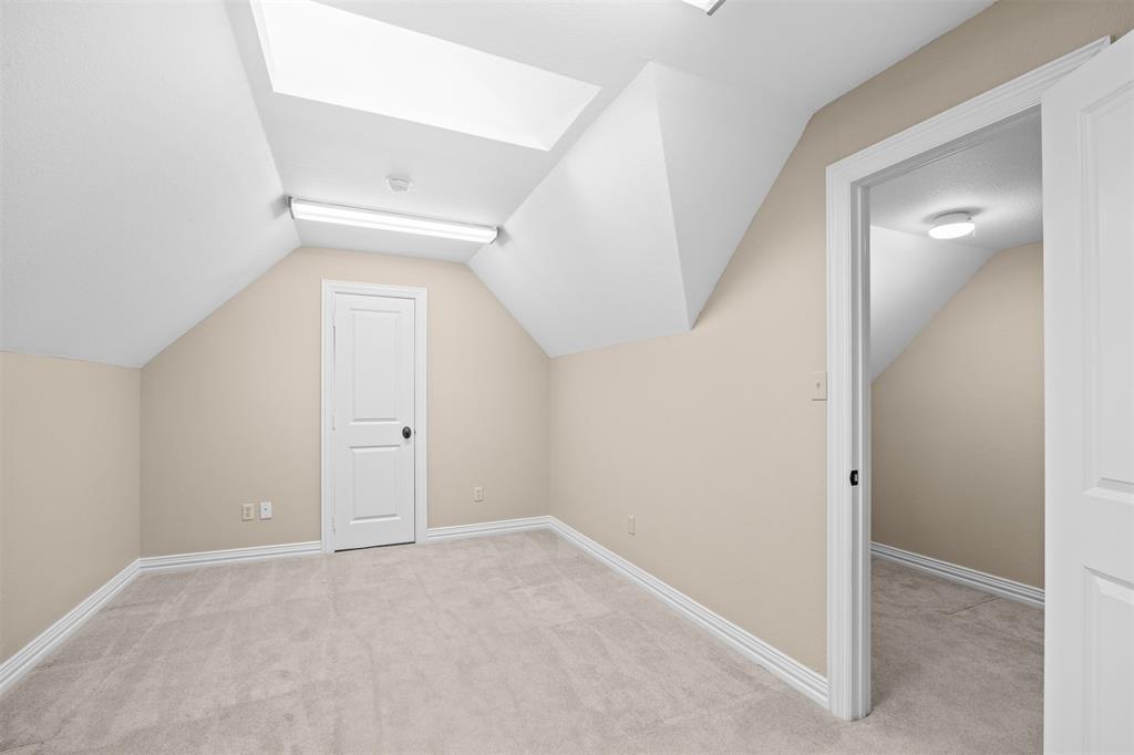 7225 Moss Ridge Road Parker, TX 75098 - Photo 18 of 40 Bonus/Flex Room featuring neutral-toned walls, light-colored carpeting, white trim, and a white door with a black knob