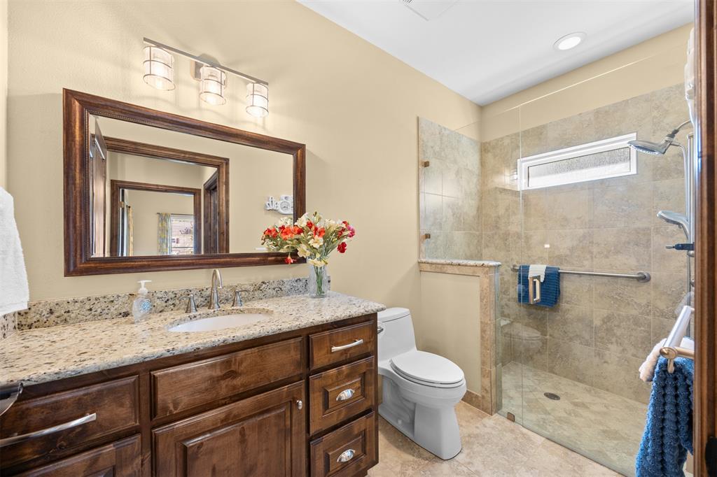 7225 Moss Ridge Road Parker, TX 75098 - Photo 25 of 40 The bathroom features a vanity with a granite countertop, a single sink, and a large framed mirror