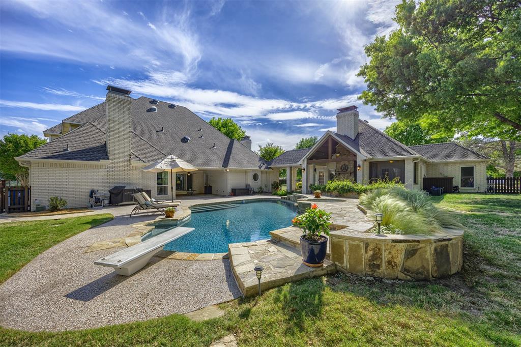 7225 Moss Ridge Road Parker, TX 75098 - Photo 27 of 40 The property features a swimming pool with a diving board, surrounded by a flagstone patio