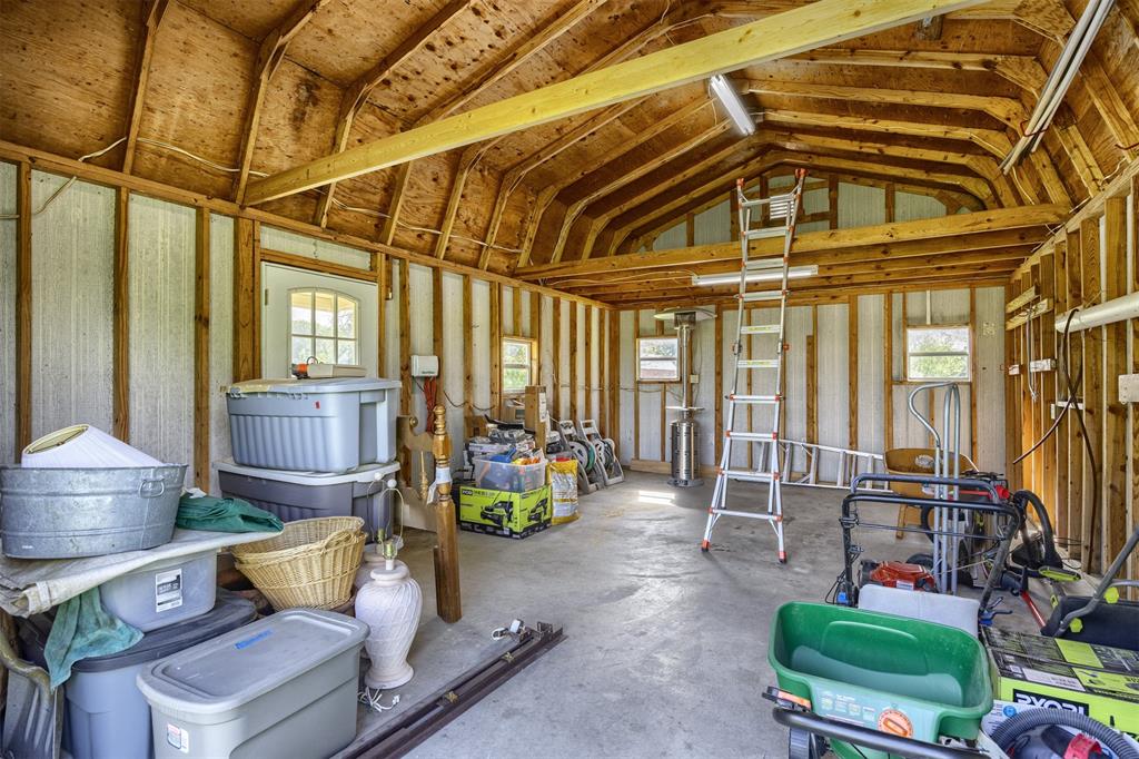 7225 Moss Ridge Road Parker, TX 75098 - Photo 30 of 40 The property features an interior space with exposed wooden beams, a concrete floor, and windows providing natural light