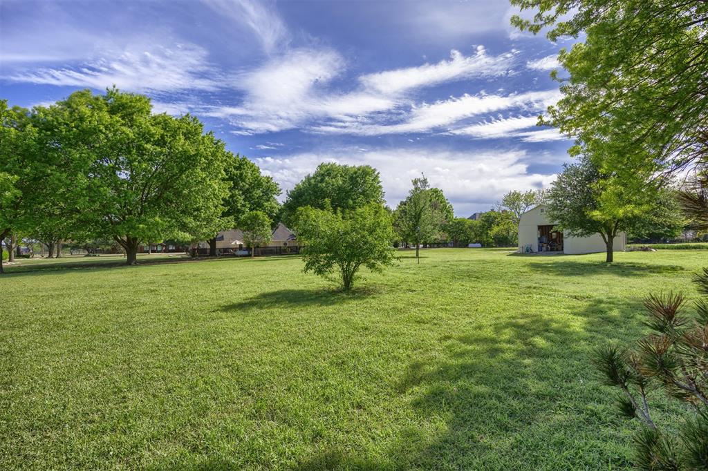 7225 Moss Ridge Road Parker, TX 75098 - Photo 31 of 40 Expansive green lawn with mature trees and a detached structure