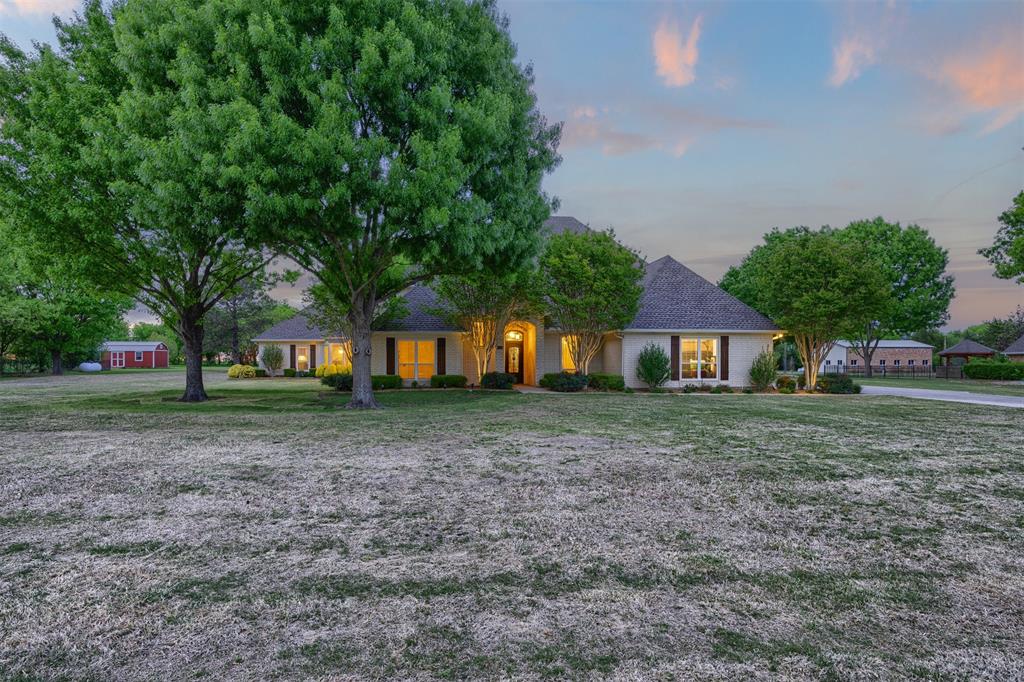 7225 Moss Ridge Road Parker, TX 75098 - Photo 34 of 40 The property features a large front lawn with mature trees and a paved driveway leading to the residence