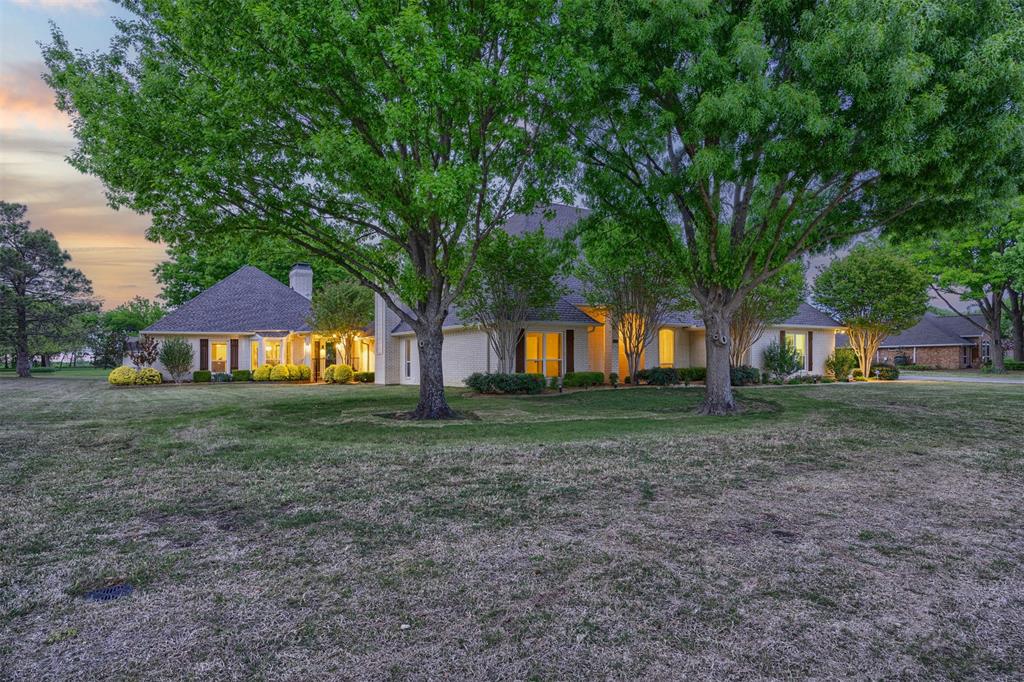 7225 Moss Ridge Road Parker, TX 75098 - Photo 35 of 40 The property features a spacious lawn and mature trees, creating a serene outdoor environment
