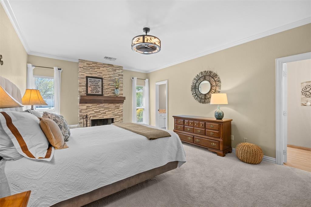 7225 Moss Ridge Road Parker, TX 75098 - Photo 9 of 40 This property features a bedroom with neutral-toned walls, carpeted flooring, and a ceiling fan with integrated lighting