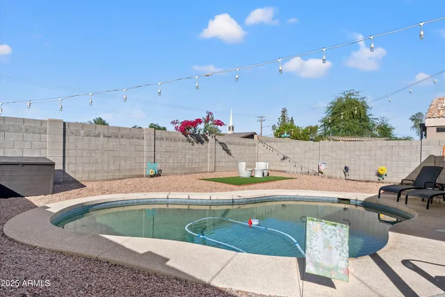 a view of a house with swimming pool and sitting area