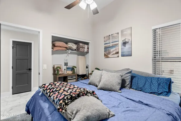 a bedroom with a bed and a painting on the wall