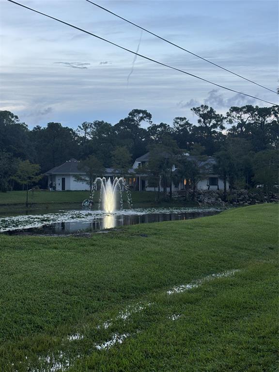 Undisclosed Address Jupiter, FL 33478 - Photo 3 of 9 a view of a lake with a big yard