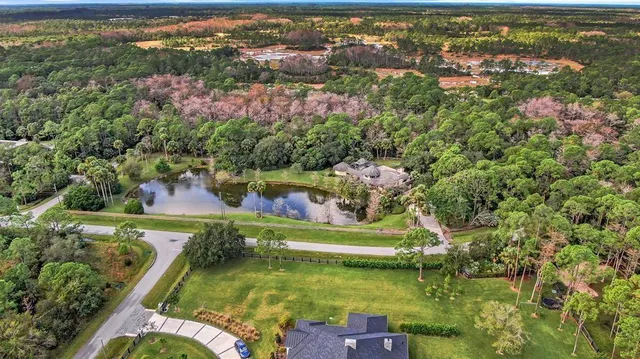 an aerial view of residential houses with outdoor space and city view