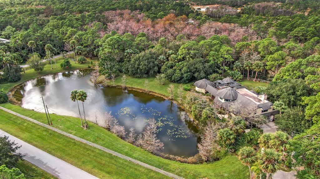 Undisclosed Address Jupiter, FL 33478 - Photo 8 of 9 a view of a lake with a yard