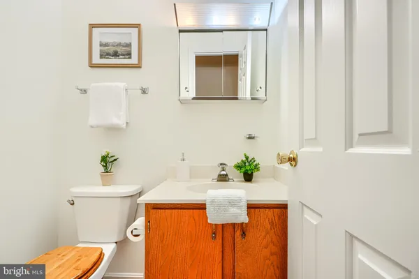 a bathroom with a sink mirror and toilet