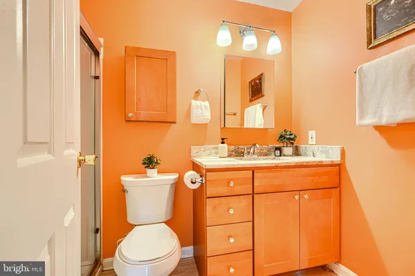 a bathroom with a toilet sink and mirror