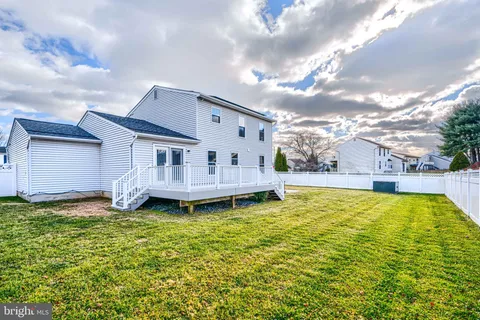 a view of a house with pool and a yard