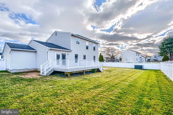 a view of a house with pool and a yard