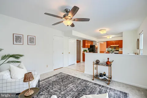 a living room with furniture and kitchen view