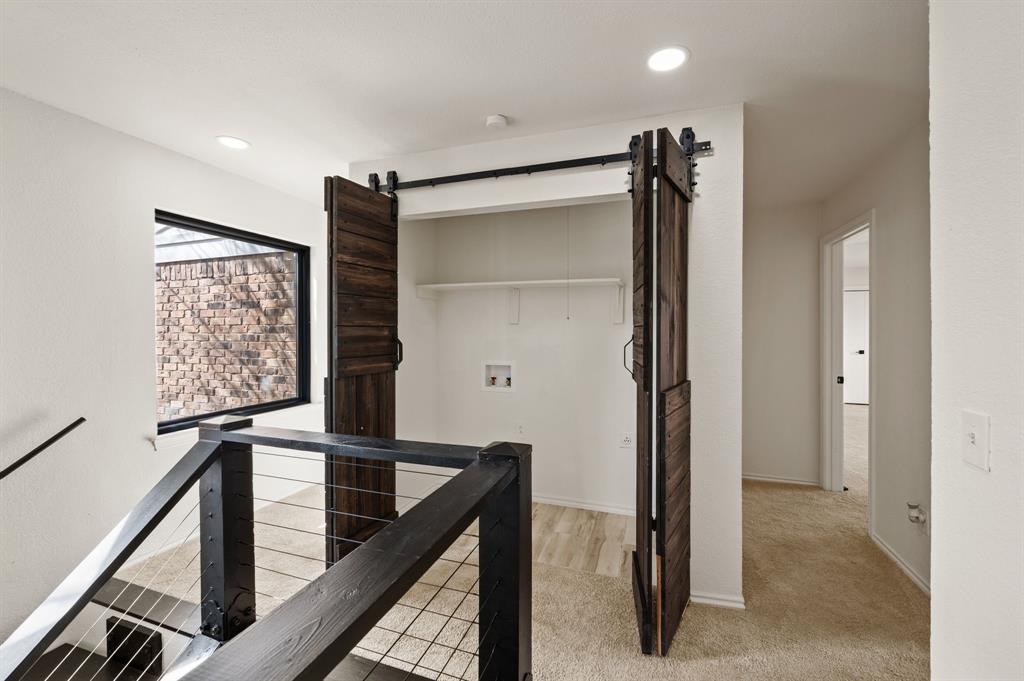 5009 Milam Street Dallas, TX 75206 - Photo 27 of 35 Corridor featuring light carpet, an upstairs landing, recessed lighting, and a barn door
