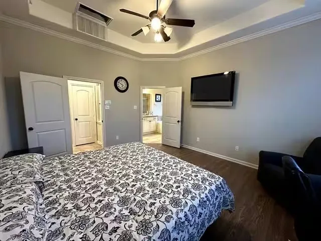 a bedroom with a bed and a flat screen tv