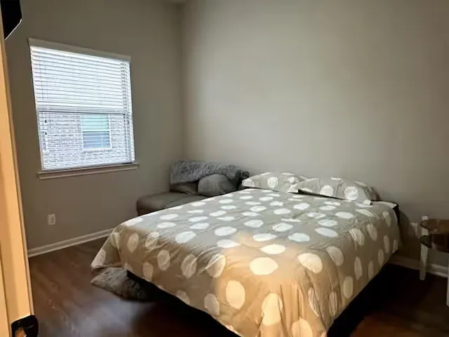 a bed sitting in a bedroom next to a window