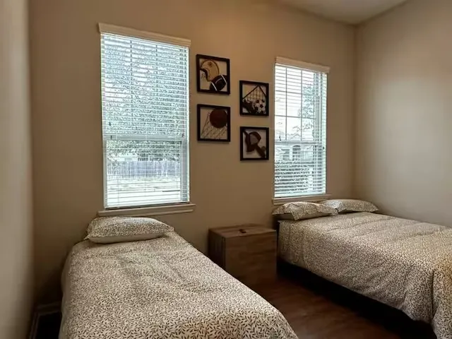 a bedroom with a bed and a window