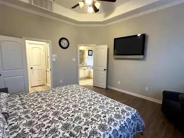 a bedroom with a bed and a flat screen tv