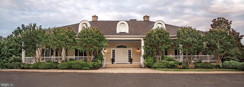 4619 Beaufont Spring Court Woodbridge, VA 22192 - Photo 41 of 42 a front view of a house with a garden