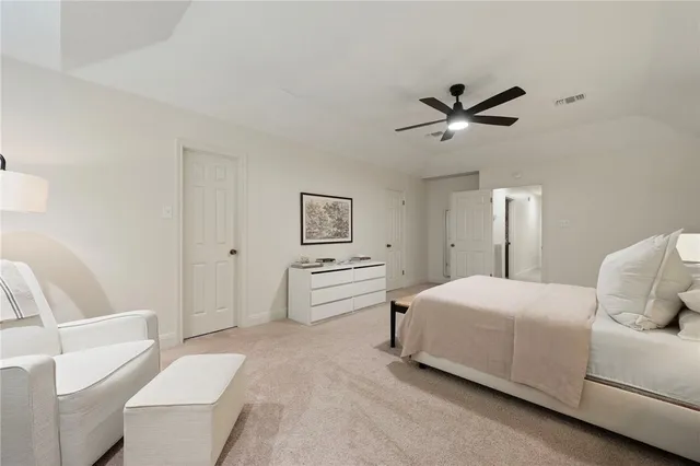 a bedroom with a white bed and white walls
