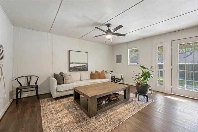 a living room with furniture and wooden floor