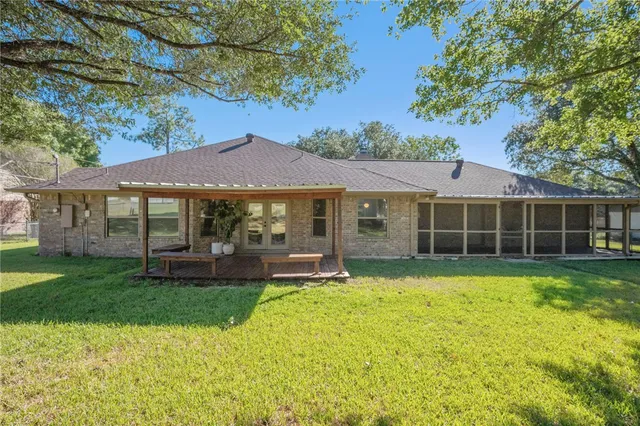 a view of a house with a yard and sitting area