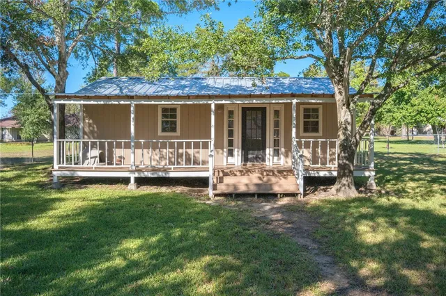 a view of a house with a yard and sitting area