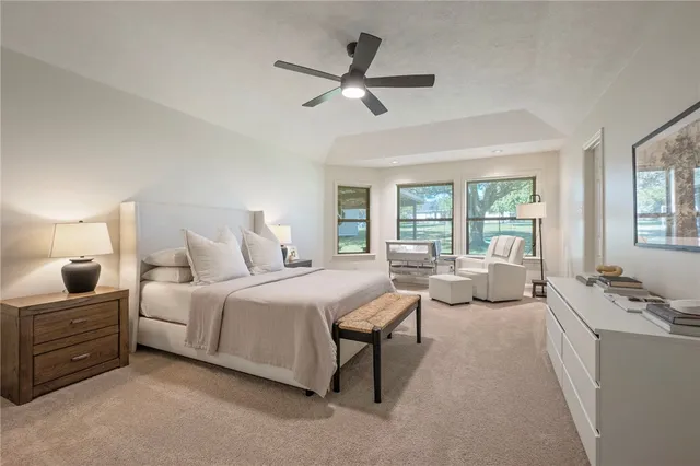 a bedroom with bed couch and window